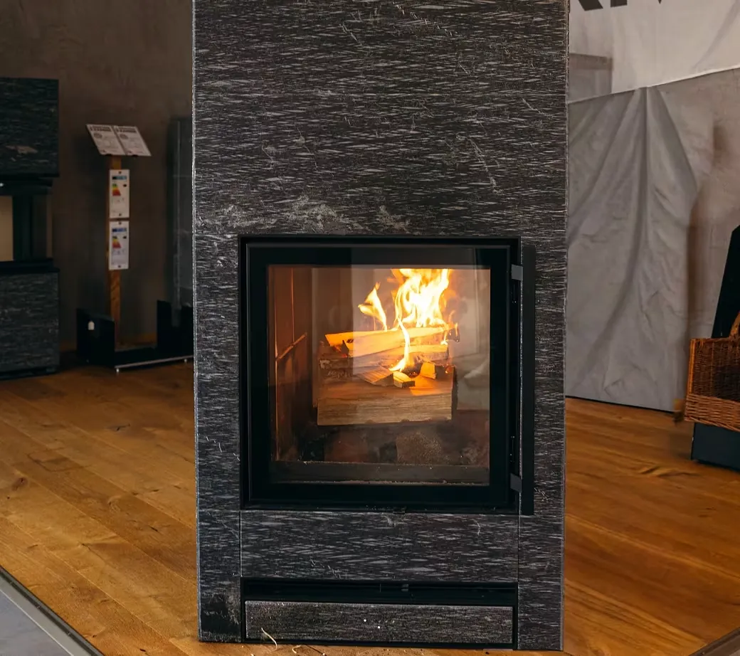 Fireplace with wood fire in a modern stone wall